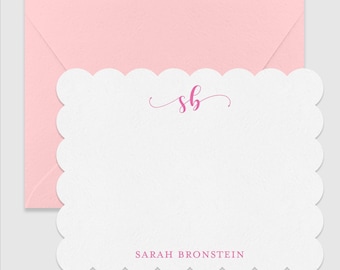 May include: A white square note card with scalloped edges and a pink envelope. The card features the pink cursive monogram "sb" at the top center and the name "SARAH BRONSTEIN" in pink capital letters at the bottom center of the card.