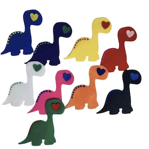 May include: A collection of colorful felt dinosaur shapes. Each dinosaur has a heart-shaped head and dotted accents. Colors include blue, navy, yellow, red, white, pink, orange, green, and black.