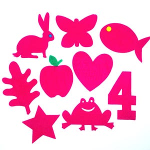 May include: A set of ten felt shapes in bright pink, including a rabbit, butterfly, fish, heart, apple, leaf, star, frog, and the number four.