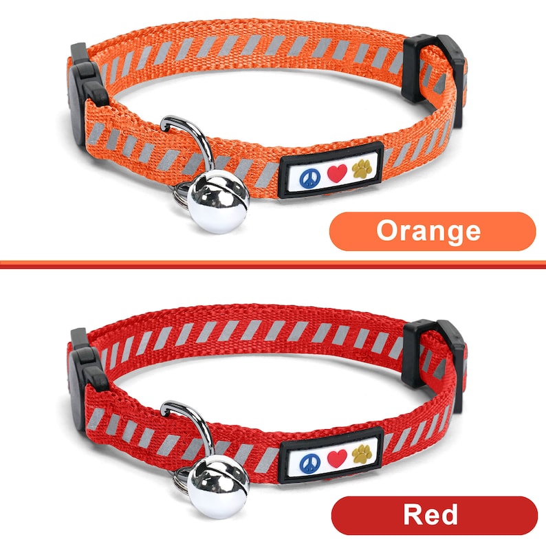 May include: Two cat collars with a bell and a peace sign, heart, and paw print charm. The collar on top is orange with reflective stripes and the collar on the bottom is red with reflective stripes. The text "Orange" is below the top collar and the text "Red" is below the bottom collar.