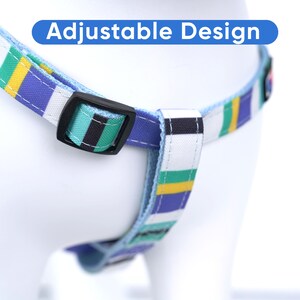 May include: A blue and white striped dog harness with an adjustable buckle. The harness has a green, yellow and black stripe pattern.