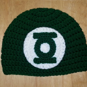 May include: Green crocheted beanie with a white Green Lantern logo.