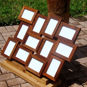 May include: A wooden picture frame collage with 12 individual frames, arranged in a unique pattern. The frames are all the same size and are made of a dark brown wood. The frames are empty and ready to be filled with photos.