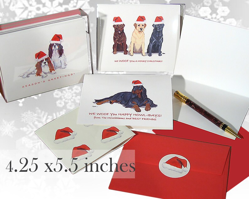 May include: A set of Christmas cards featuring dogs wearing Santa hats. The cards are 4.25 by 5.5 inches and come with red envelopes. The cards feature different breeds of dogs, including a Cavalier King Charles Spaniel, a Labrador Retriever, and a Gordon Setter.