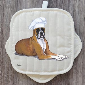 May include: A handmade wooden sign with the text "Welcome to our home" in a handwritten style. The sign is painted white with a distressed finish and features a dark brown border. A small, decorative heart is attached to the bottom.