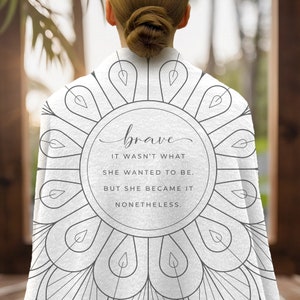 May include: White throw blanket with a grey mandala design and the text "brave it wasn't what she wanted to be. but she became it nonetheless."