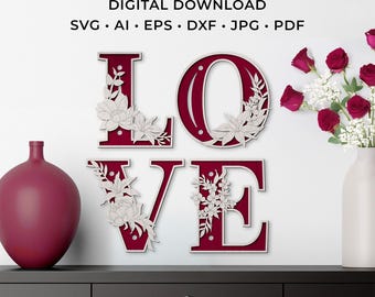 May include: A burgundy "LOVE" sign with laser-cut floral accents. The letters are displayed on a white wall, with a vase of red roses and a burgundy vase on a black surface. The image also includes the text "LASER CUT FILE DIGITAL DOWNLOAD".