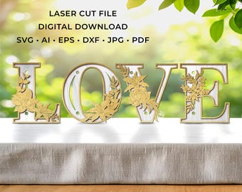 May include: Wooden "LOVE" sign with gold floral accents. The letters are white with a gold border and floral embellishments. The sign is a laser cut file digital download in SVG, AI, EPS, DXF, JPG, and PDF formats.