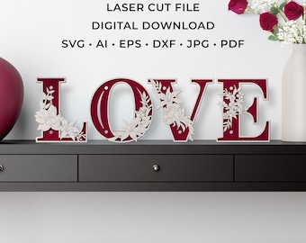 May include: A burgundy wooden sign spells out the word "LOVE", with each letter decorated with laser-cut floral designs. The sign is a digital download, with file formats including SVG, AI, EPS, DXF, JPG, and PDF.