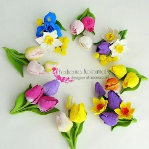 May include: A collection of colorful, handcrafted flower arrangements, including tulips, daffodils, and irises, arranged in a circular pattern. The flowers feature shades of pink, purple, yellow, and blue, with green leaves. The text "Yevheniia Kolomiets designer of accessories" is also visible.