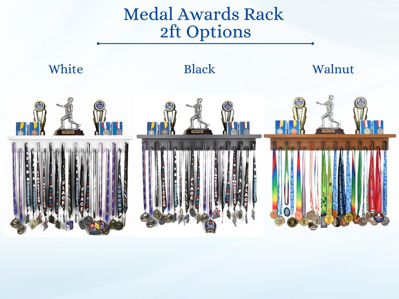 May include: Medal display racks in white, black, and walnut. Each rack holds medals and features a shelf with trophies and a figurine. The text "Medal Awards Rack 2ft Options" is at the top.