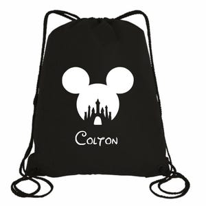 May include: Black drawstring bag with a white silhouette of Mickey Mouse's head with the Disney castle inside. The name "Colton" is printed below the silhouette.