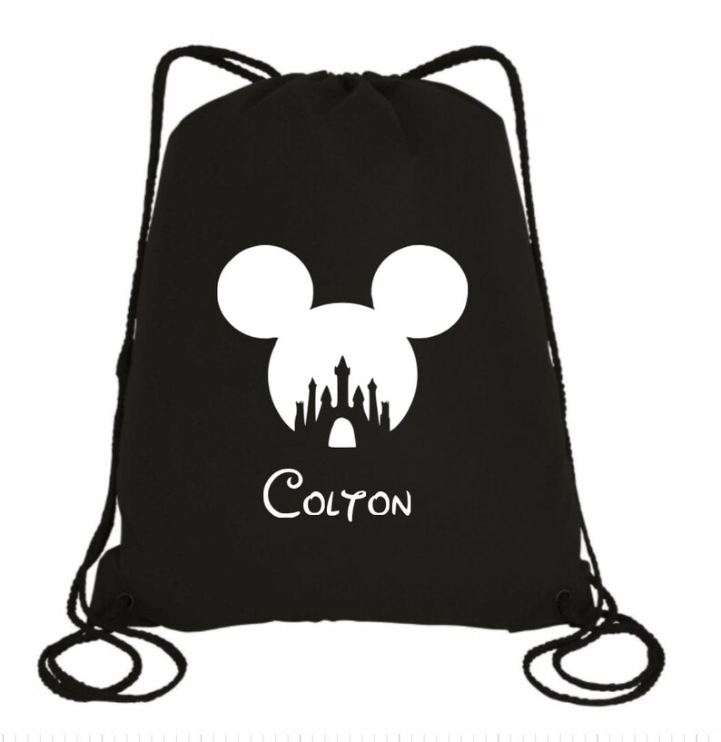 May include: Black drawstring bag with a white silhouette of Mickey Mouse's head with the Disney castle inside. The name "Colton" is printed below the silhouette.