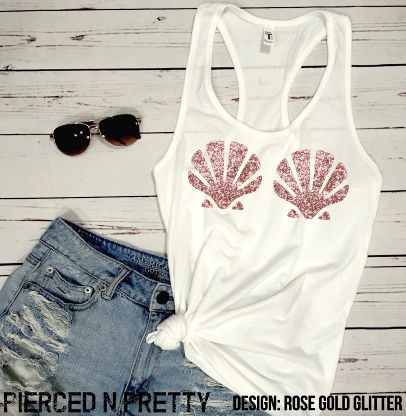 May include: White tank top with rose gold glitter seashell design. The top is paired with denim shorts and sunglasses. The text "Pierced N Pretty" and "Design: Rose Gold Glitter" are visible.