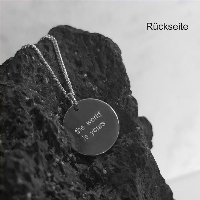 May include: A silver necklace with a round pendant that says "the world is yours".