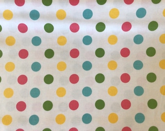 May include: White fabric with a repeating pattern of colorful polka dots. The dots are yellow, green, blue, and pink.