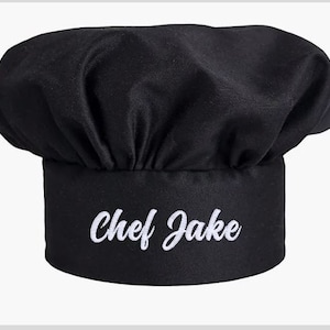 May include: Black chef hat with white embroidery that reads "Chef Jake".