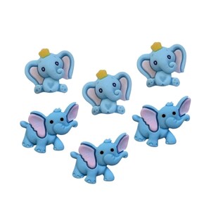 May include: A collection of six light blue elephant-shaped embellishments. Each elephant has large pink ears, a yellow crown, and is in a sitting or walking position. These decorative elements are ideal for craft projects.