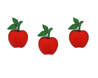 May include: Three red apple-shaped embellishments with green leaves and stems. These decorative elements are likely used for crafts, scrapbooking, or other DIY projects. The apples are a vibrant red color, and the leaves are a contrasting green.