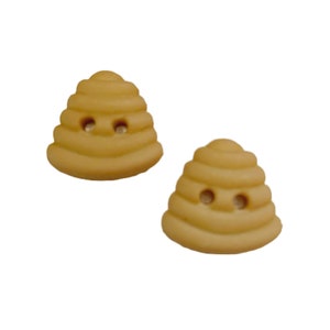 May include: Two light yellow beehive-shaped buttons. Each button has a layered design and two small holes, resembling eyes. The buttons are made of a smooth material and are set against a white background. These buttons are ideal for sewing and craft projects.