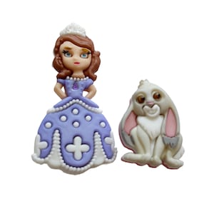 May include: Two decorative figurines: a princess in a lavender dress with a white crown and a white bunny with pink ears. The princess has brown hair and blue eyes. The bunny is sitting down.