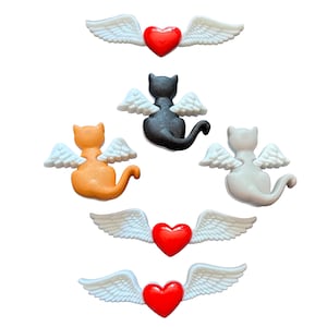 May include: A collection of cat and heart-shaped embellishments with angel wings. The cats are in orange, black, and white. The hearts are red, and the wings are white. These decorative elements are ideal for crafts and DIY projects.