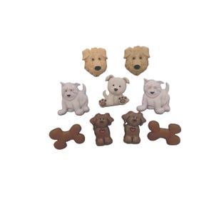 May include: A collection of decorative dog-themed buttons in various colors and styles. The buttons include tan, white, and brown dog faces, sitting dogs, and brown bone shapes. These buttons are ideal for craft projects.