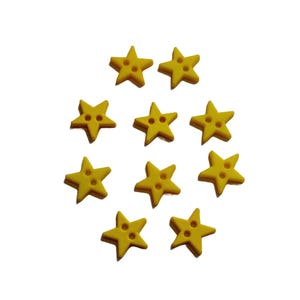 May include: A collection of ten yellow star-shaped buttons. Each button has five points and two holes for sewing. The buttons are arranged in a loose circular pattern against a white background.