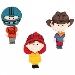 May include: Three decorative buttons shaped like cartoon characters. One wears a teal football helmet and orange jersey with 00, one wears a red fire helmet with the word FIRE, and one wears a brown cowboy hat with a blue shirt and red pants.