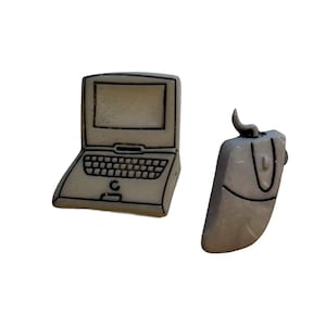 May include: A computer-themed set of earrings featuring a laptop and a mouse. The earrings are a light gray color with black outlines, giving them a cartoonish appearance. The laptop has a keyboard and screen.