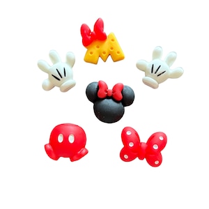 May include: A collection of colorful resin embellishments featuring iconic cartoon character elements. Includes white gloves, red bows, a black head with a red bow, a red head, and a yellow cheese wedge with a red bow.