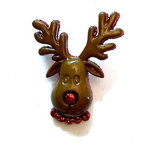 May include: A brown reindeer head ornament with red glitter accents. The reindeer has a red glitter nose and a red glitter collar. The antlers are brown with red glitter trim. This festive decoration is perfect for Christmas.