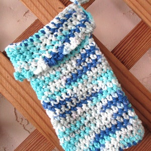 May include: A crocheted phone case in shades of blue, white, and gray. The case has a flap that folds over the top of the phone.