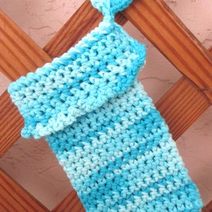 May include: A crocheted blue and light blue washcloth with a crocheted loop at the top.