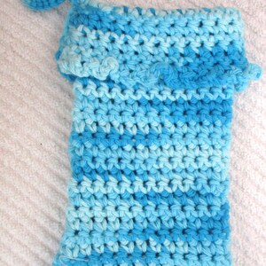 May include: A blue and light blue crocheted washcloth with a crocheted loop handle.