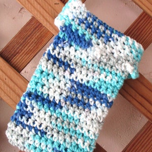 May include: A blue, white, and turquoise crocheted dishcloth with a white loop at the top.