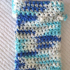 May include: A crocheted blue, white, and gray washcloth with a loop handle.