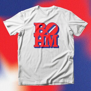 May include: White t-shirt with a red and blue graphic that says "BOHM" on it.