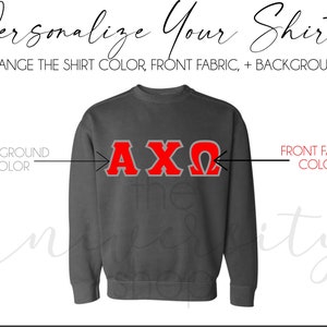 May include: A gray sweatshirt with the letters AX&Omega; in red on the front. The text "Personalize Your Shirt!" is at the top of the image. The text "Change the shirt color, front fabric, + background" is below the text "Personalize Your Shirt!" The text "Background Color" is on the left side of the image and the text "Front Fabric Color" is on the right side of the image.