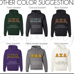 May include: A collage of ten different color sweatshirts with the letters "AXA" in gold on the front. The sweatshirts are in the colors forest green, charcoal, black, purple, athletic heather, white, navy, red, pink, and yellow.