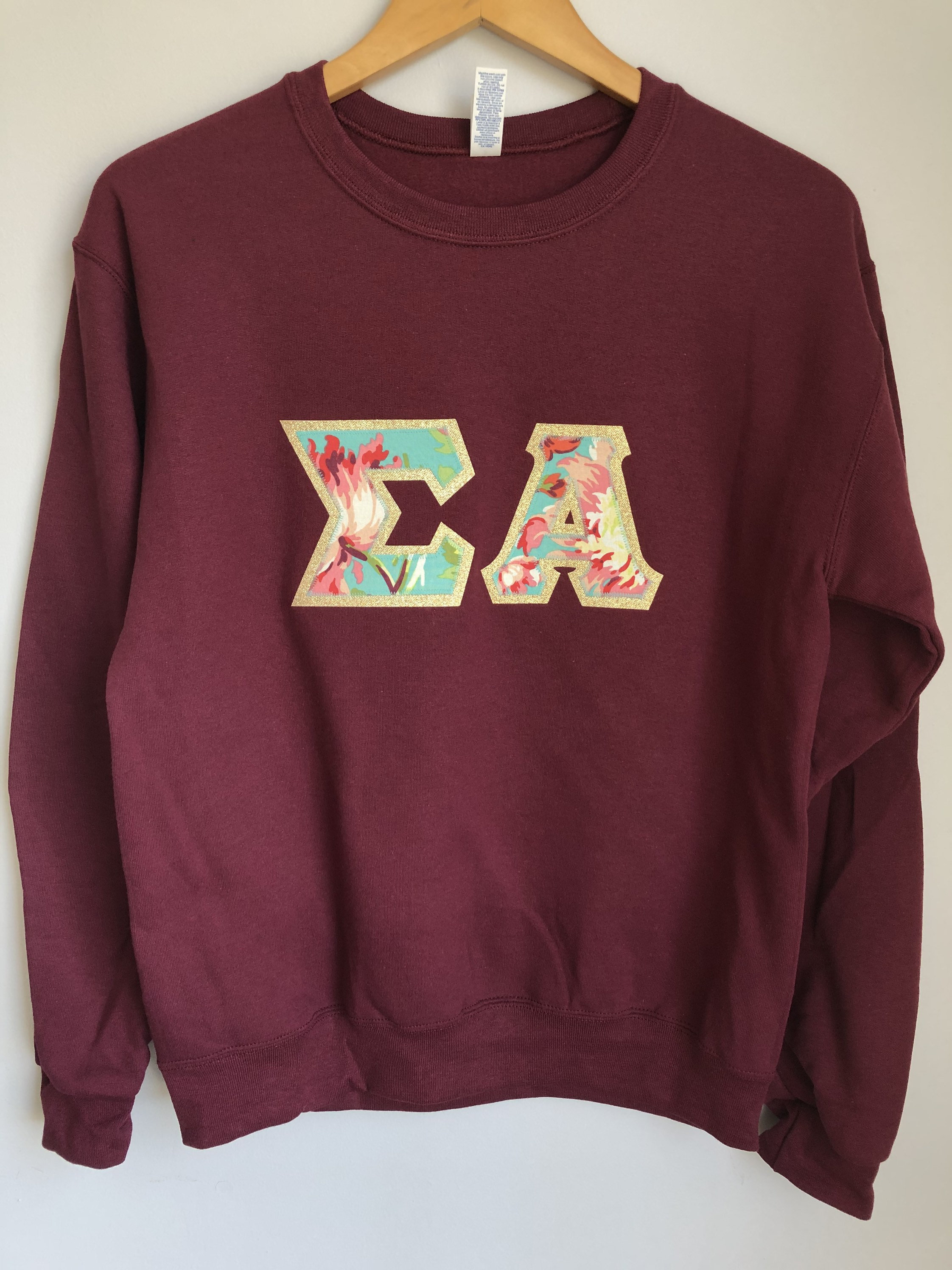 UniversityShop Maroon Crewneck Sweatshirt with Greek Letters in Amy Butler Bliss Bouquet on Gold Metallic (254C)