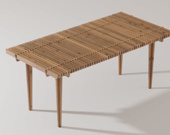 May include: A wooden table with a slatted top and four legs. The table is made of light brown wood and has a natural finish.