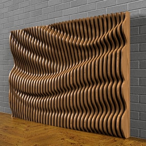 May include: A wooden wall panel with a wavy, undulating design. The panel is made of thin, vertical strips of wood that are arranged in a repeating pattern. The panel is a light brown color and has a natural wood finish.