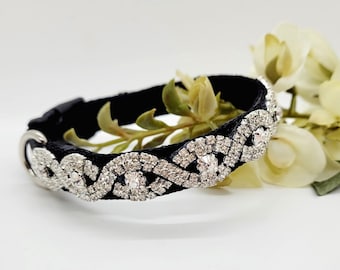 May include: A black velvet pet collar with a silver rhinestone design. The collar is decorated with a wavy pattern of rhinestones.