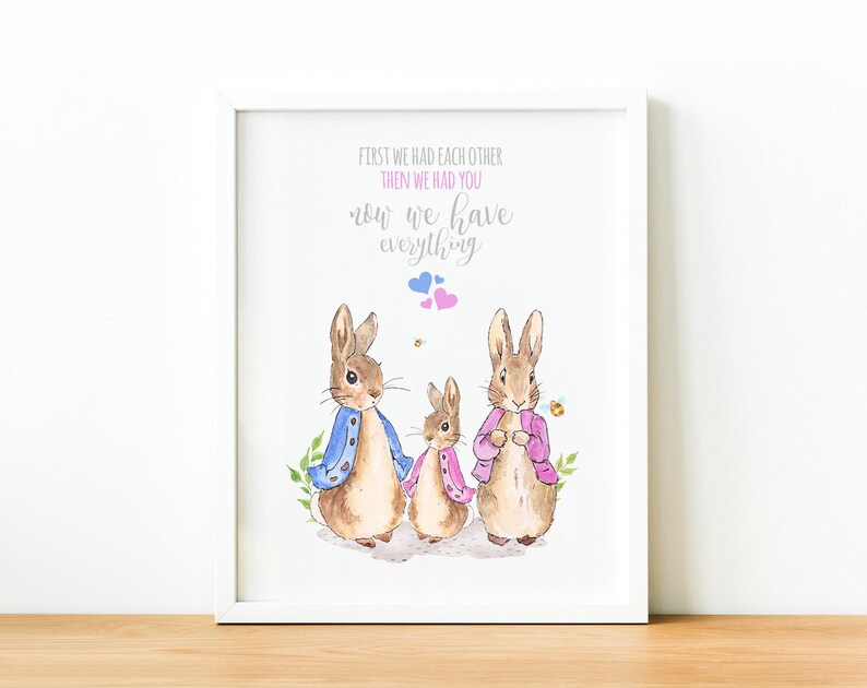 May include: A watercolor illustration of a family of three rabbits with the text "First we had each other, then we had you, now we have everything". The rabbits are wearing blue and pink jackets and are standing on a white background.