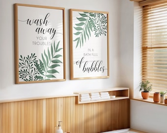 May include: Two framed prints with a white background and green leafy designs. The left print says "wash away your troubles" and the right print says "in a bath full of bubbles".