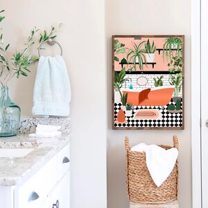 May include: A bathroom interior design print featuring a bathtub with plants and a black and white checkered floor. The print is framed in wood and hung on a white wall.