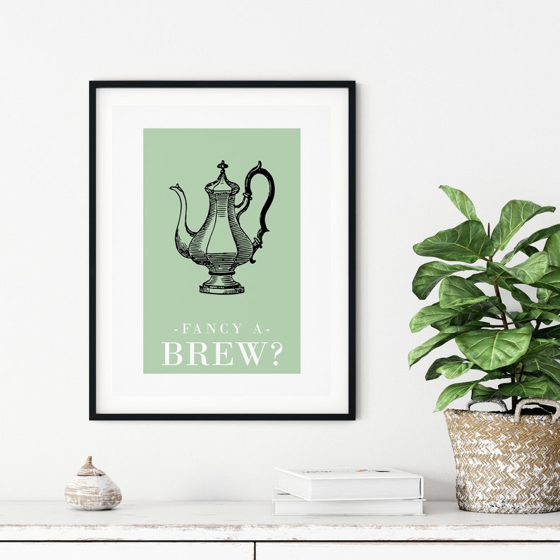 May include: A black and white illustration of a teapot on a green background with the text "Fancy a Brew?" in white.
