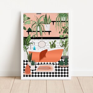 May include: A pink bathroom with a white tiled wall and a freestanding orange bathtub. The bathtub has a white towel and a round mirror above it. There are many green plants in the bathroom, including a large plant in a white pot on a shelf.