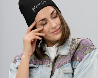 May include: Black beanie with the text "Rebel Eye" embroidered in white on the front.